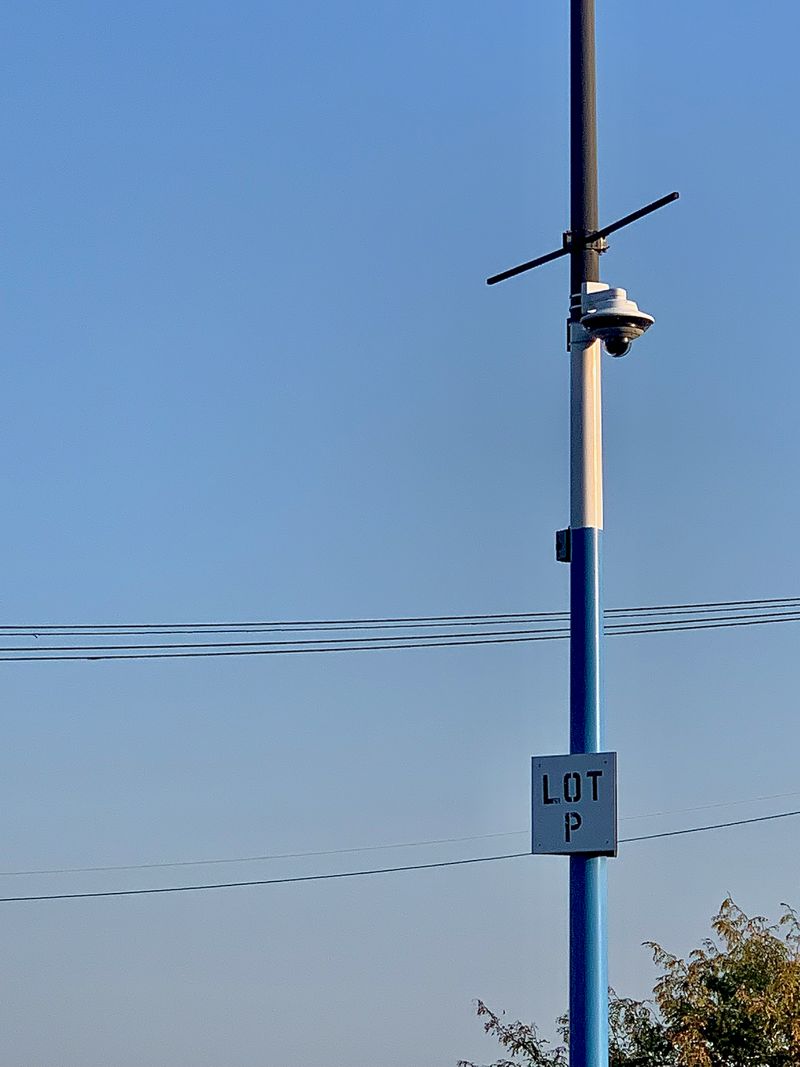 A lonely closed-circuit camera surveilling an empty parking lot labeled Lot P.